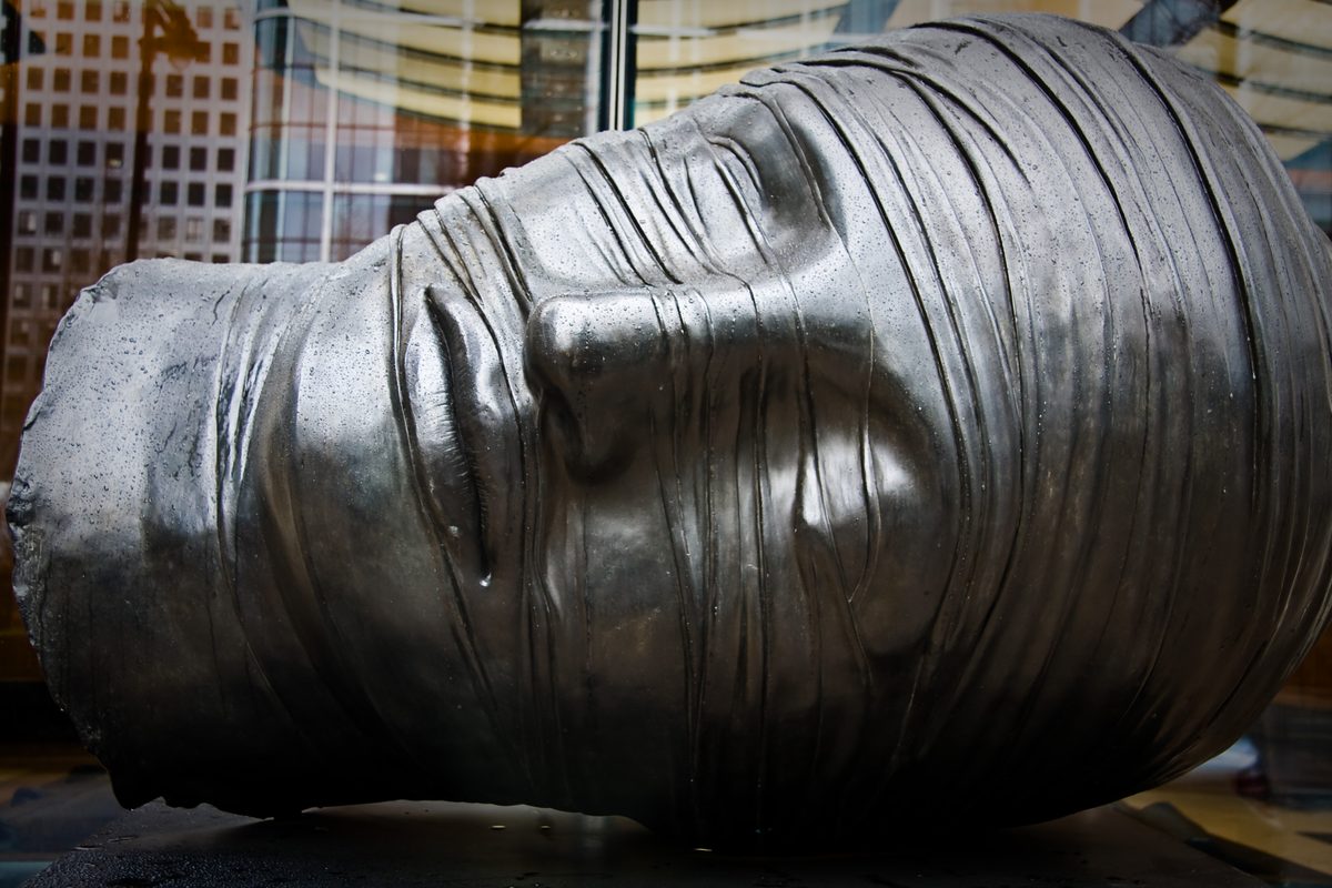 Testa Addormentata by Igor Mitoraj at Canary Wharf, London