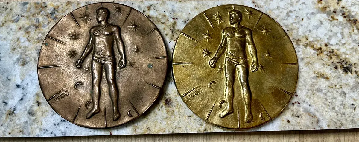 Mitoraj Articulations — both medal variants, centered close crop on marble