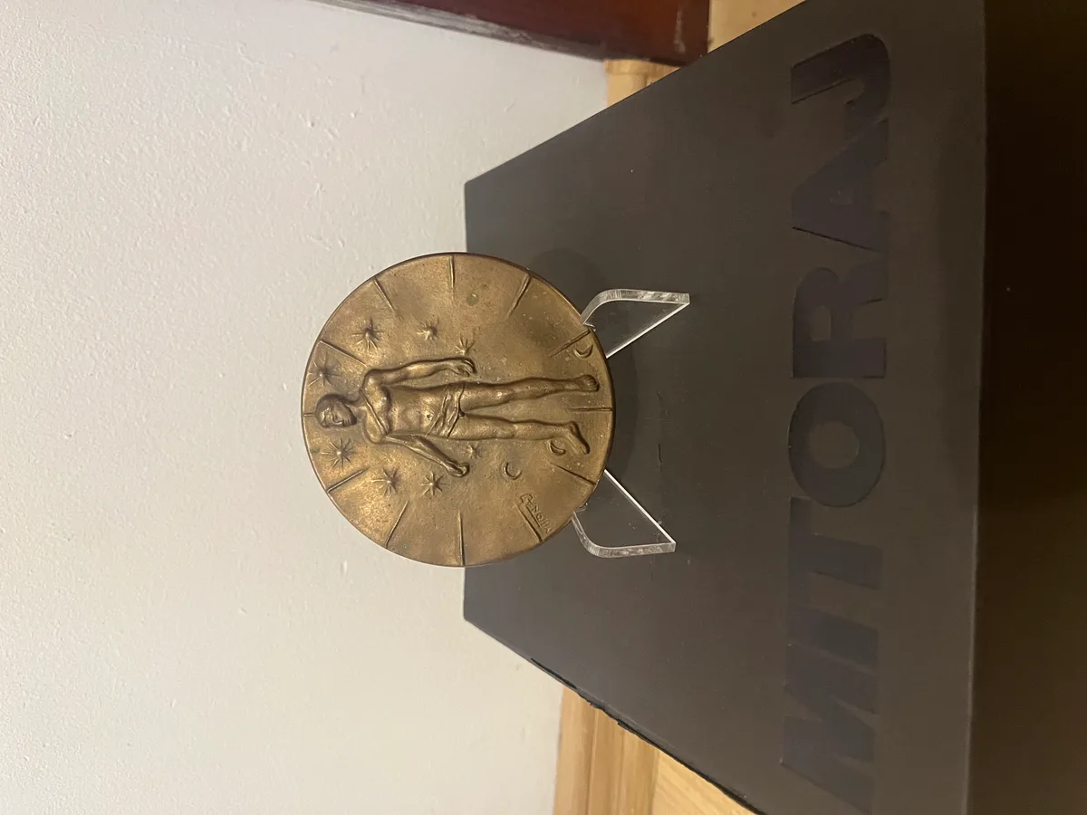 Mitoraj Articulations — bronze medal on stand with original Mitoraj catalogue, collector photograph
