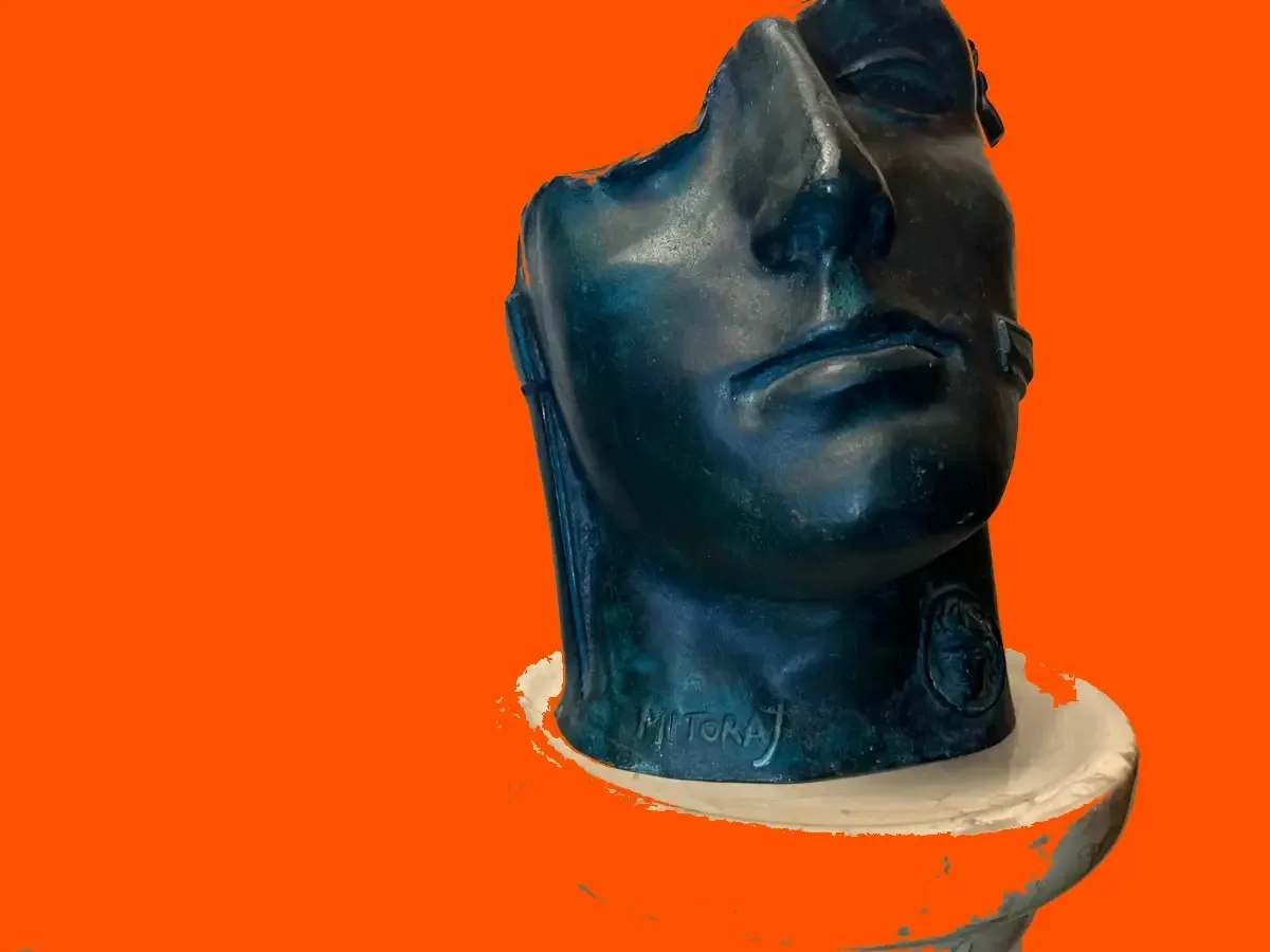 Centurione II (1987) — Igor Mitoraj, dark patina bronze, front view, fire orange background, Ed. 1500