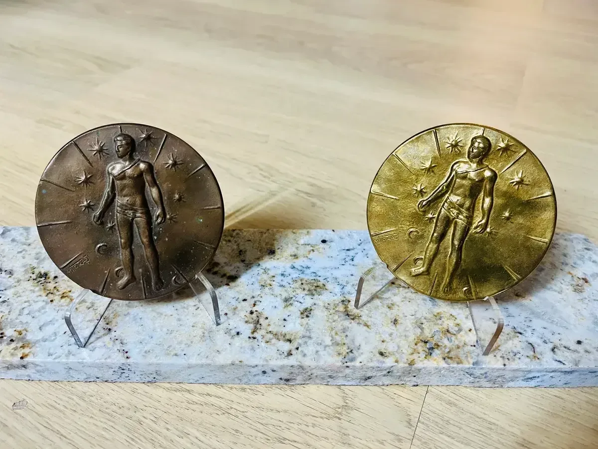 Artcurial Mitoraj medals — dark and gilt patina