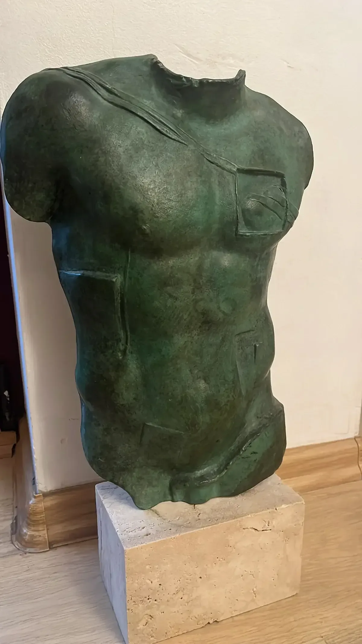 Persée (1988) — Igor Mitoraj, green patina bronze, angled view showing chest aperture