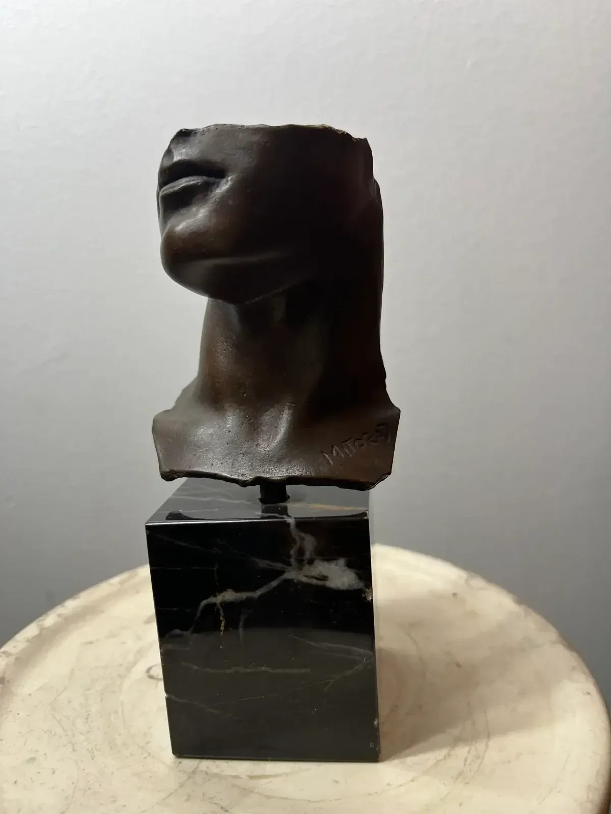 Portrait d'Homme (1984) — Igor Mitoraj, bronze, medal patina, with white marble pedestal