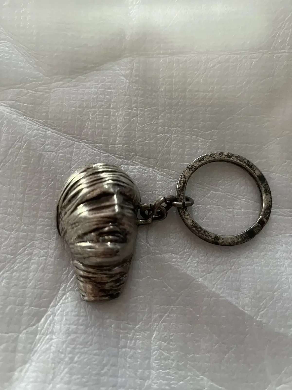Testa Addormentata (Amnesty International) — Igor Mitoraj, silver pendant three-quarter view, private collection