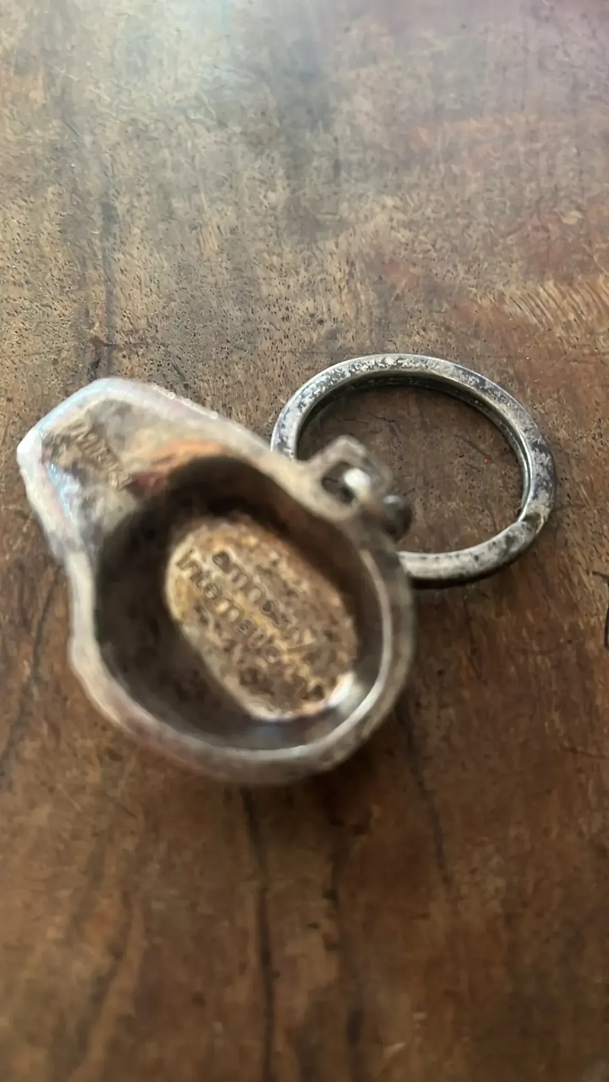 Testa Addormentata (Amnesty International) — Igor Mitoraj, silver pendant angled view, private collection