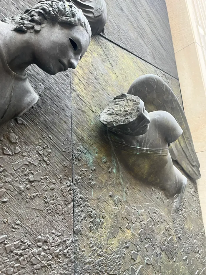 Anielskie Drzwi — wing tip above angel head, Mitoraj door detail, Warsaw
